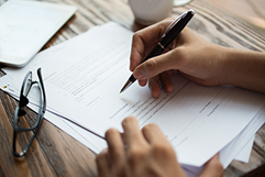 businessman-examining-papers-table 1