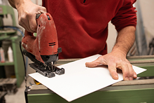 young-male-with-red-sweater-making-something-with-industrial-tools 2